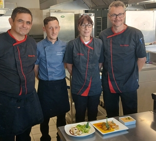 Le personnel du restaurant scolaire devant 3 assiettes du grand repas